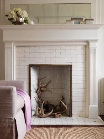 Antlers make a statement displayed in this off-season fireplace