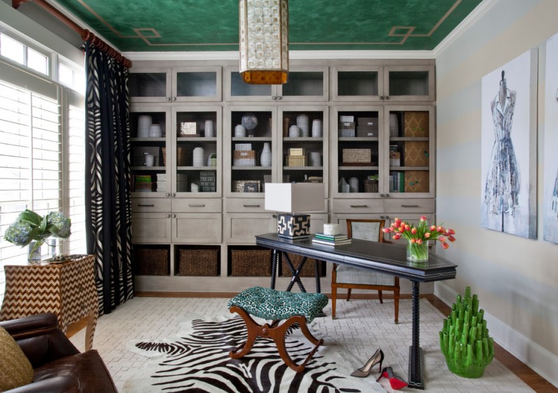 A zebra print rug accents a lush green ceiling in a diva's home office.