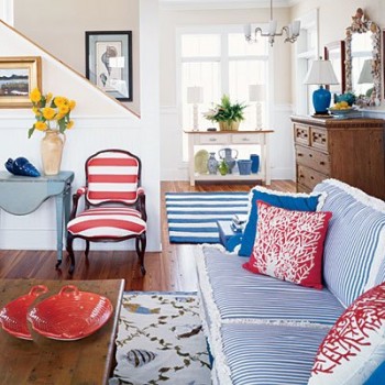 Red pillows and a dish add pops of color to this blue and white interior