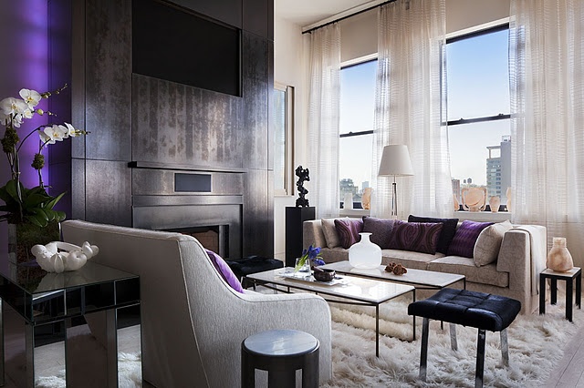 A living room incorporating the basics of interior design featuring purple accents and a fireplace.