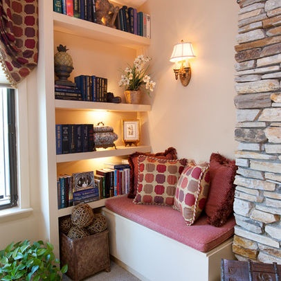 A cozy living room with a fireplace and bookshelves.