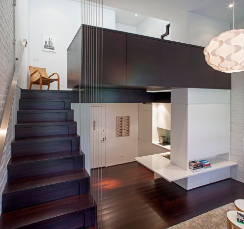 A loft space with stairs and a desk.
