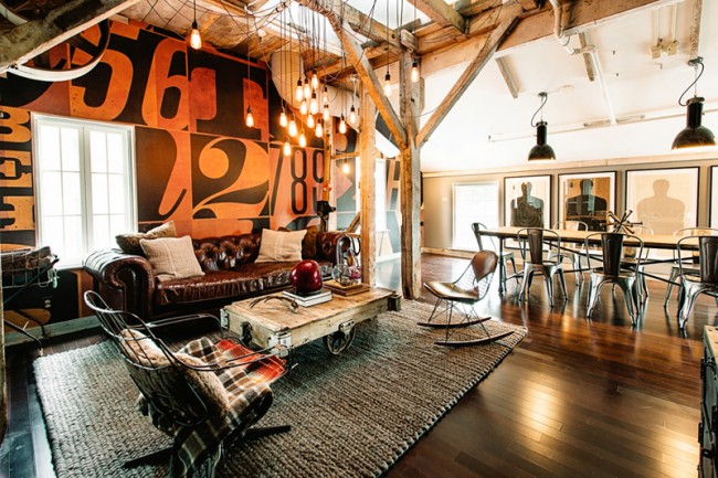 A loft space with wooden beams and a leather couch.