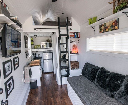 A cozy tiny house with a loft designed for comfortable living.