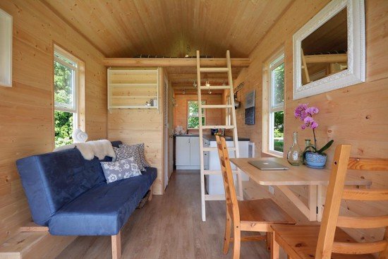 A cozy tiny house showcasing a couch and table perfect for minimalist living.