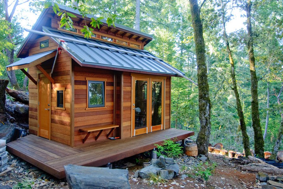 A cozy tiny house nested in the woods.