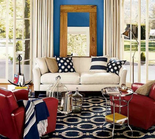 A living room showcasing the basics of interior design with blue walls and red furniture.