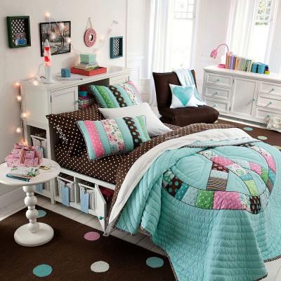 A bedroom with a bed and a bedside table, designed for girls.