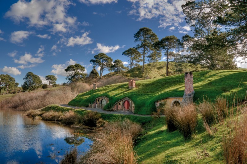 Experience the real Middle-Earth with Hobbit houses on the side of a lake in New Zealand.
