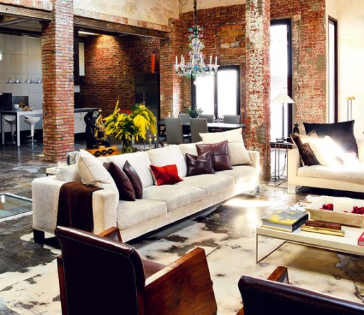 A warehouse converted into a cozy living room with couches and a coffee table.