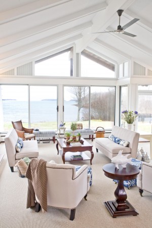 A coastal living room with a ceiling fan.