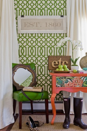 A green and white latticework patterned wallpaper in a room.