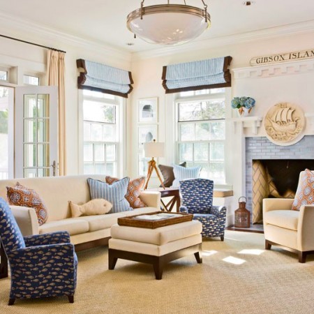 A coastal cottage living room with blue and white furniture and a fireplace.