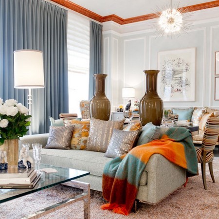 A living room with decorative pillows in blue and orange.