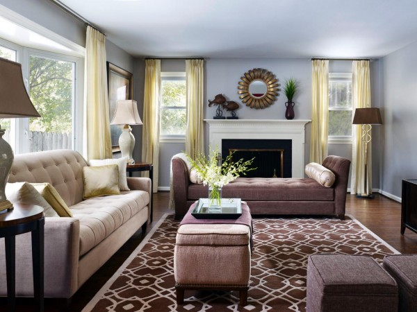 A staged living room with beige furniture and a fireplace.