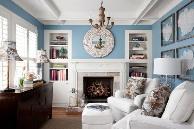 A coastal cottage living room with blue walls and white furniture.