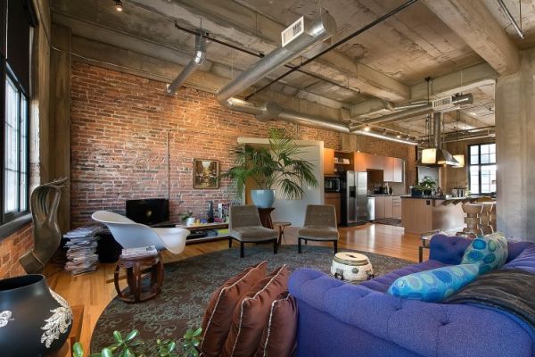 A loft living room transformed from a warehouse with exposed brick walls.