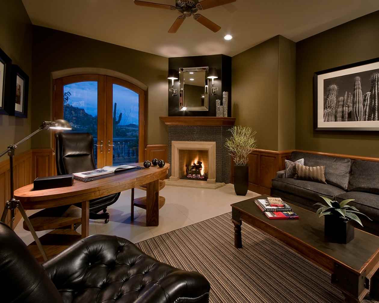 A masculine home office with a fireplace and leather furniture.