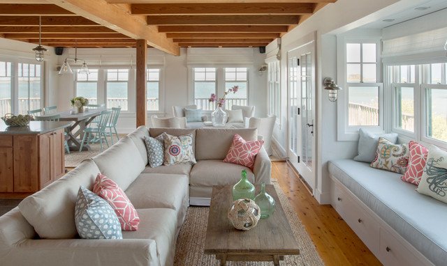 A coastal living room with a large window overlooking the ocean.