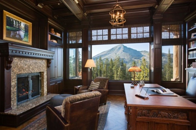 A masculine home office with a view of the mountains.