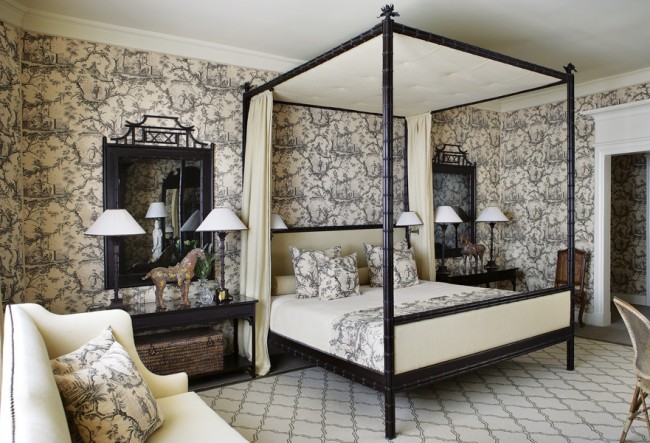 A black and white toile bedroom with a four poster bed.