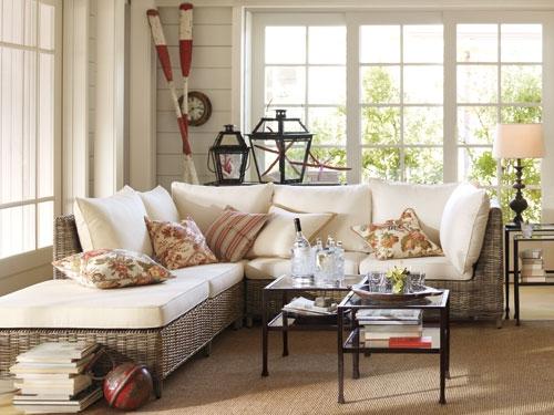 A coastal cottage with wicker furniture and a coffee table.