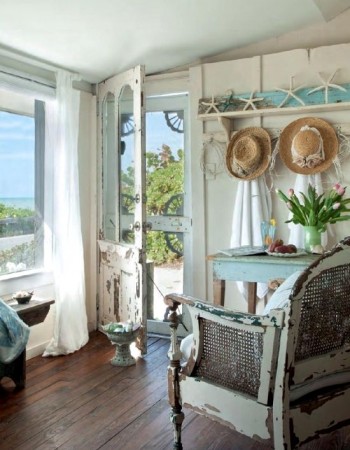 A coastal cottage bedroom with a view of the ocean.