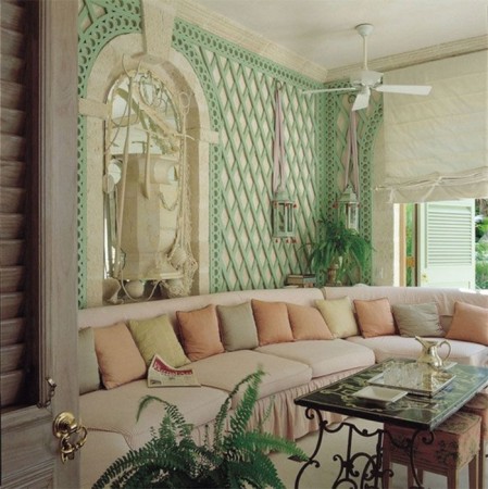 A green couch with latticework in a living room.