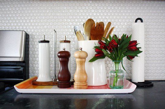 A tray with salt and pepper shakers, utensils, perfect for staging your home.