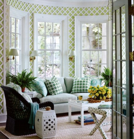 A living room with green and white latticework-patterned wallpaper.