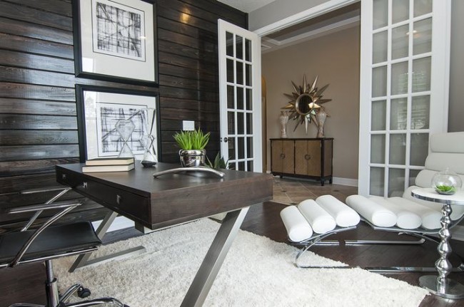 A modern, masculine home office with a white desk and chair.