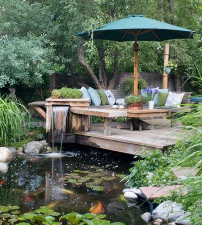 Making the Most of Your Backyard Deck with a koi pond and patio furniture.