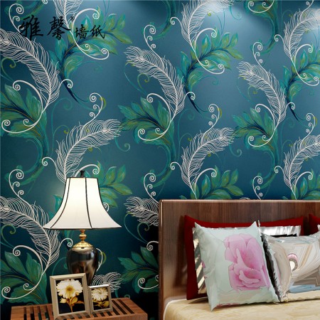 A bedroom with a blue and green wallpaper designed to Feather Your Nest.