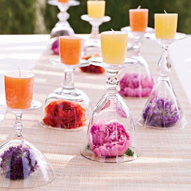Glass candle holders with flowers on a table, perfect for decorating.