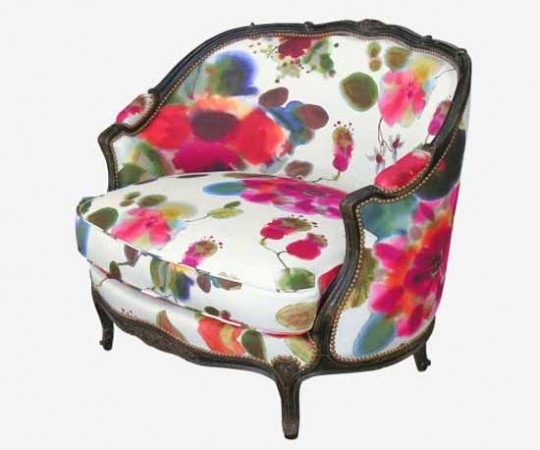 A floral upholstered chair with a watercolor design.