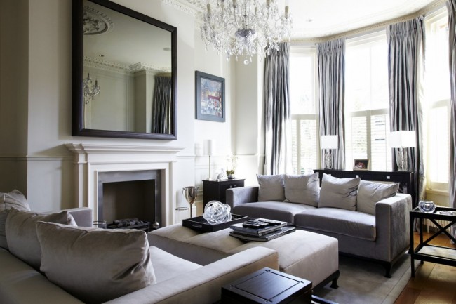 A living room with a fireplace taking modern to the Victorian age.
