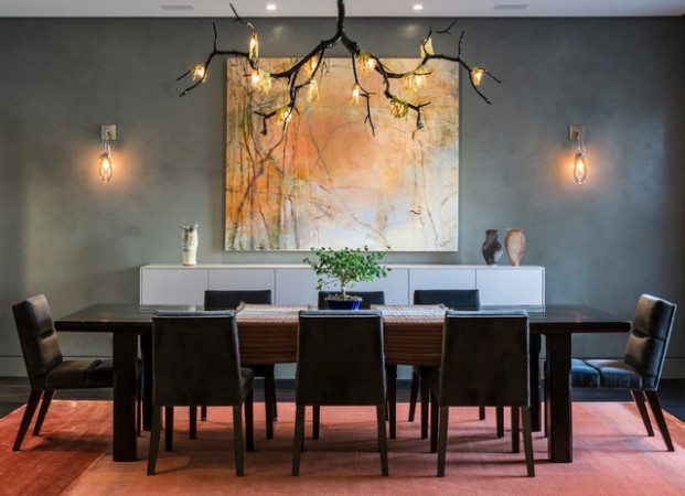 A modern dining room with a large painting above the table, ideal for a stylish home.