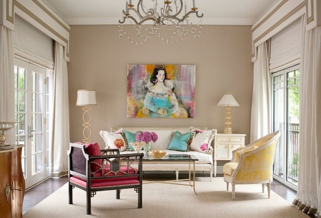 A living room with colorful furniture and a chandelier, showcasing stylish decor essentials.