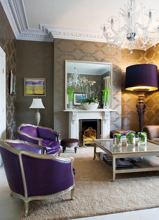 A stylish home with purple chairs and a fireplace.