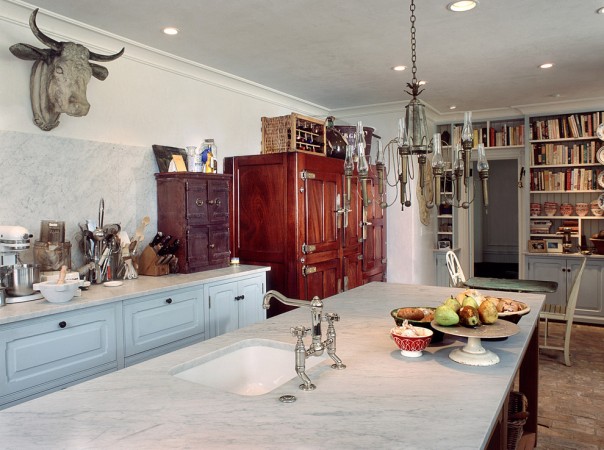 A kitchen with a unique cow head hanging from the ceiling, serving as wine room design inspiration.