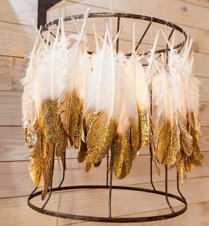 A chandelier adorned with golden feathers.