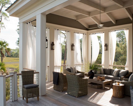 Outdoor Space with wicker furniture and white curtains.