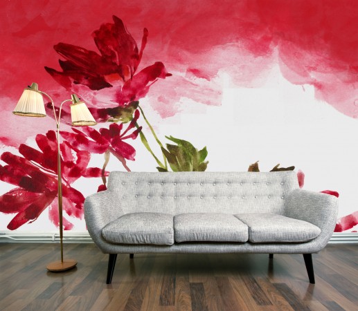 A watercolor-inspired couch in front of a vibrant flower wall mural.