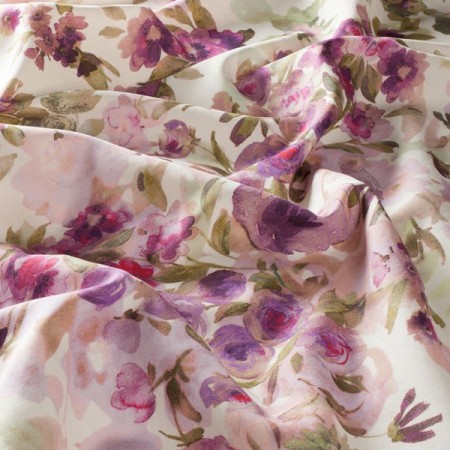 A close up of a purple and pink watercolor floral print.