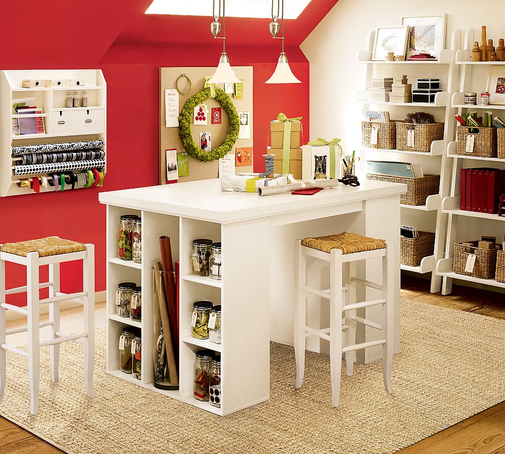 A room with a white table and stools featuring design tips for storage in a craft room.