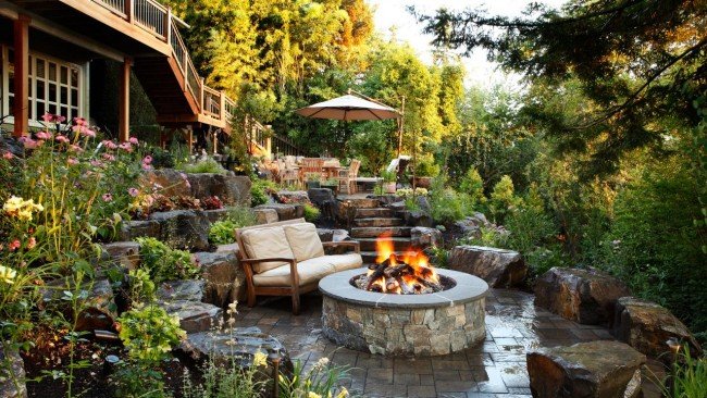 A beautiful waterfall accents this outdoor living area