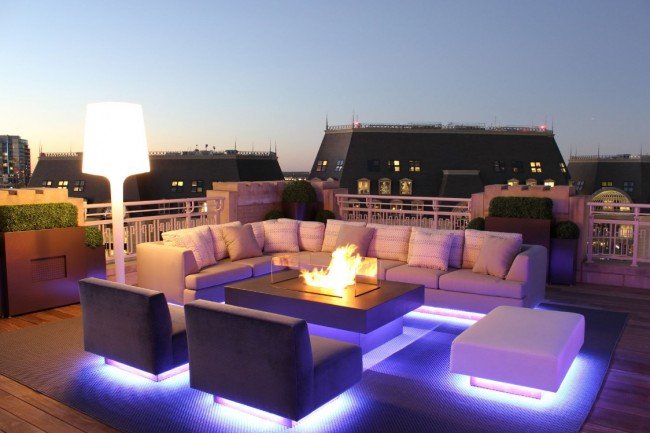 Unique lighting highlights this rooftop living space 