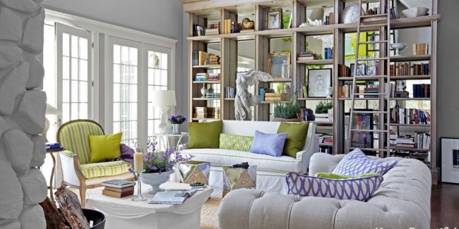A living room with bookshelves and couches - Stylish Home