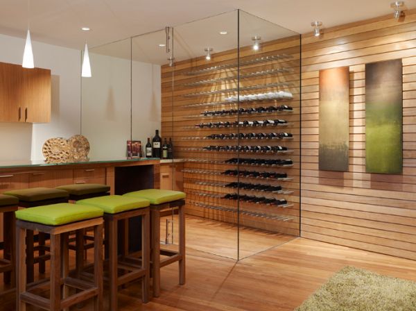 A modern wine cellar with wooden wall and green stools, providing design inspiration and storage tips for a wine room.