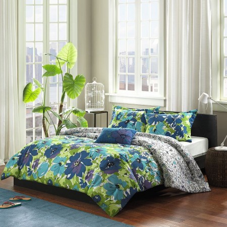 A watercolor floral comforter set in a bedroom with a blue and green color scheme.